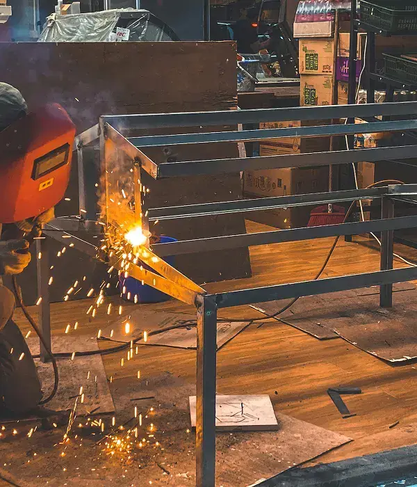 Welder joining a steel frame on site