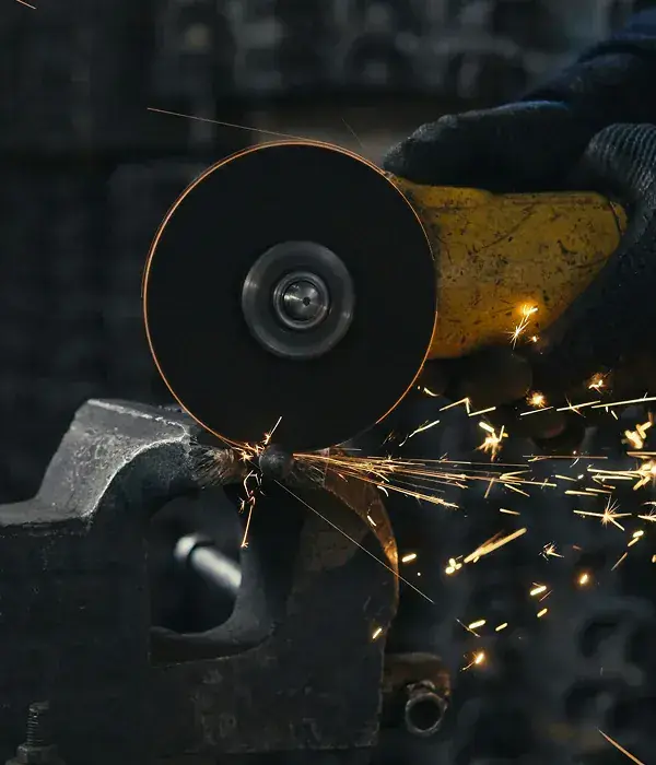 Angle grinder cutting steel with sparks