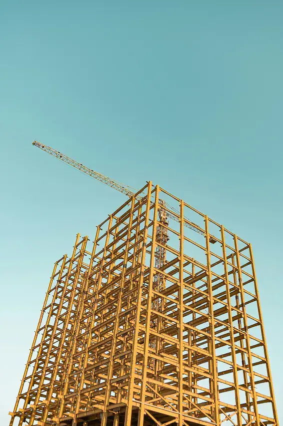 Steel tower frame under construction with a crane